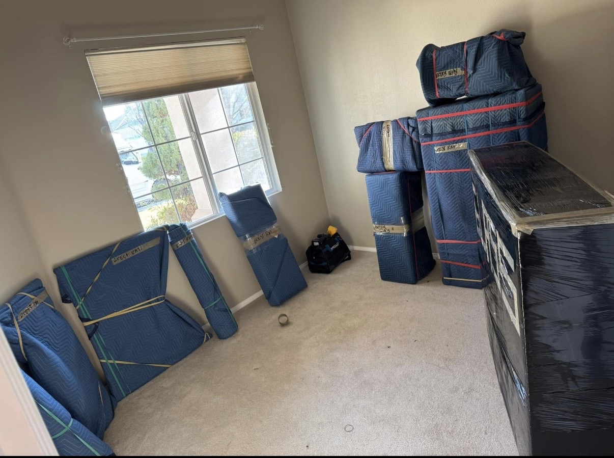 Furniture and boxes wrapped and labeled for a move by Ventura Bros