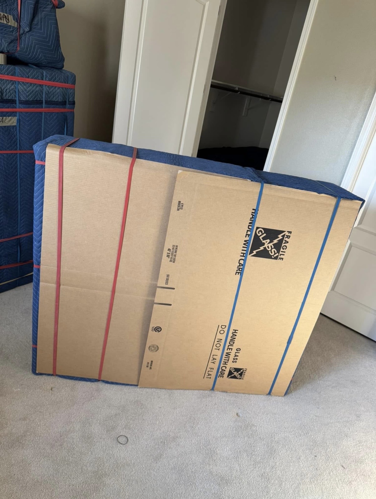 Mirror protected with cardboard and moving blankets for safe packing
