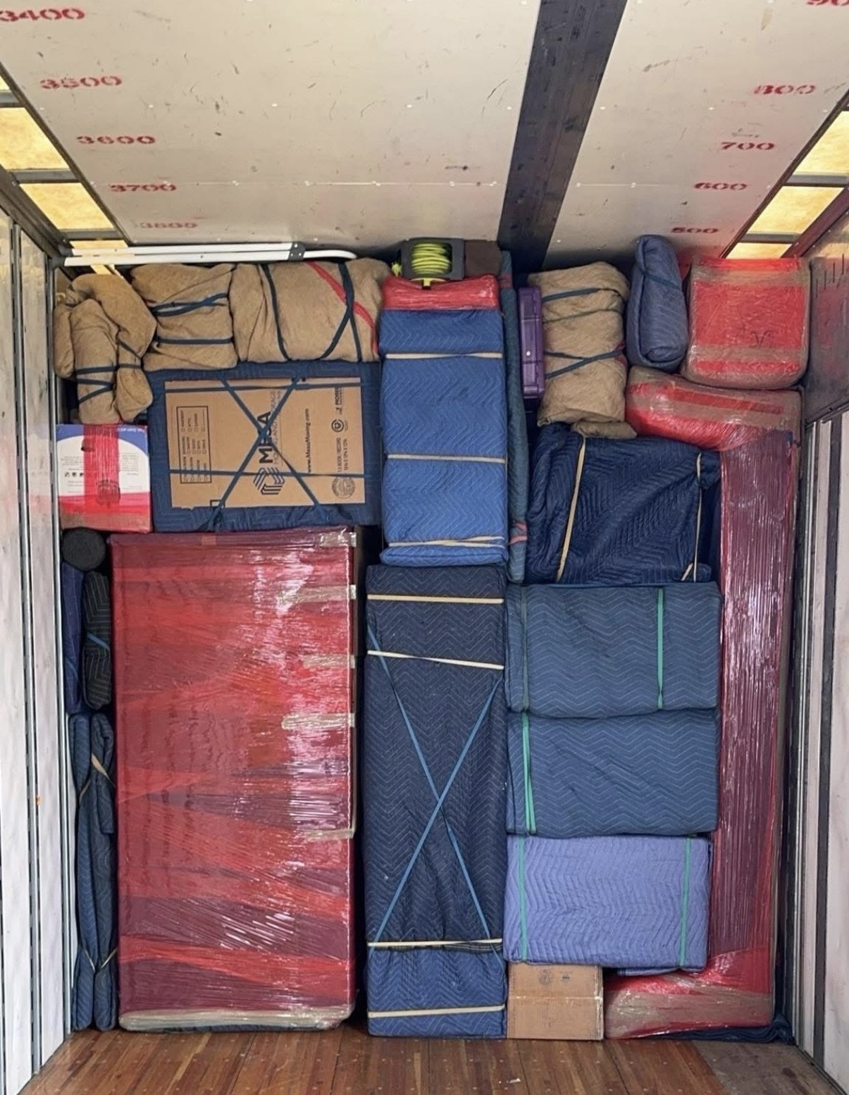Moving truck packed tightly with furniture and boxes for a long-distance move